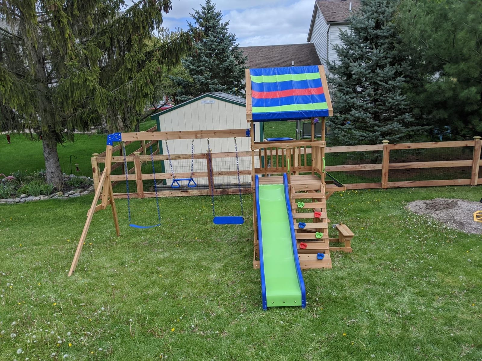 Backyard Discovery Beach Front Cedar Wood Swing Set with Wave Slide, Play Deck, Monkey Bars, Rock Wall Ladder, Shaded Picnic Area, Snack Bar, Belt Swings, Trapeze, Sandbox Area, Outdoor Playset customer photo 2